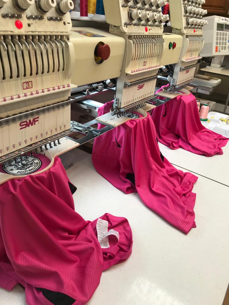 WearYourLogo embroidery machines producing branded garments