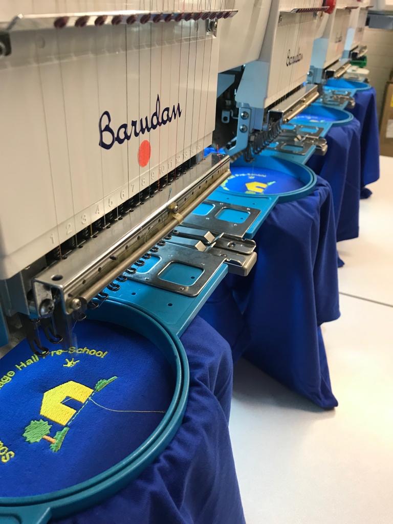 Multi-head embroidery machines producing school garments