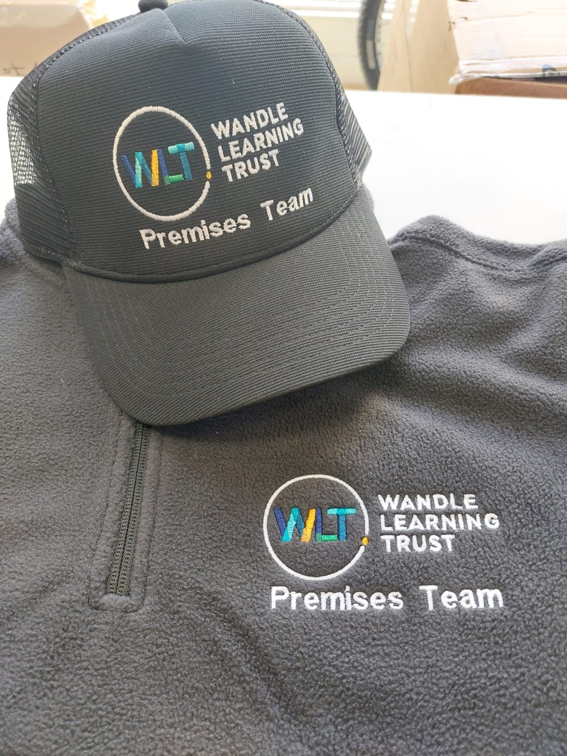 Matching embroidered cap and fleece for a customer team