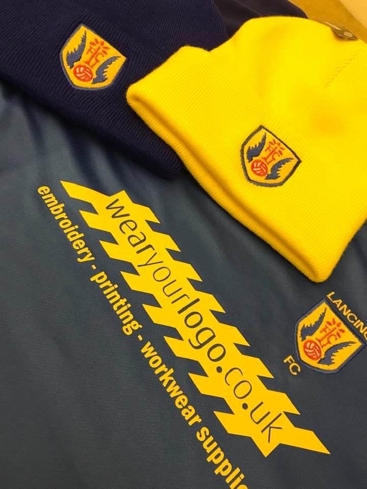 School crest embroidered onto red clothing
